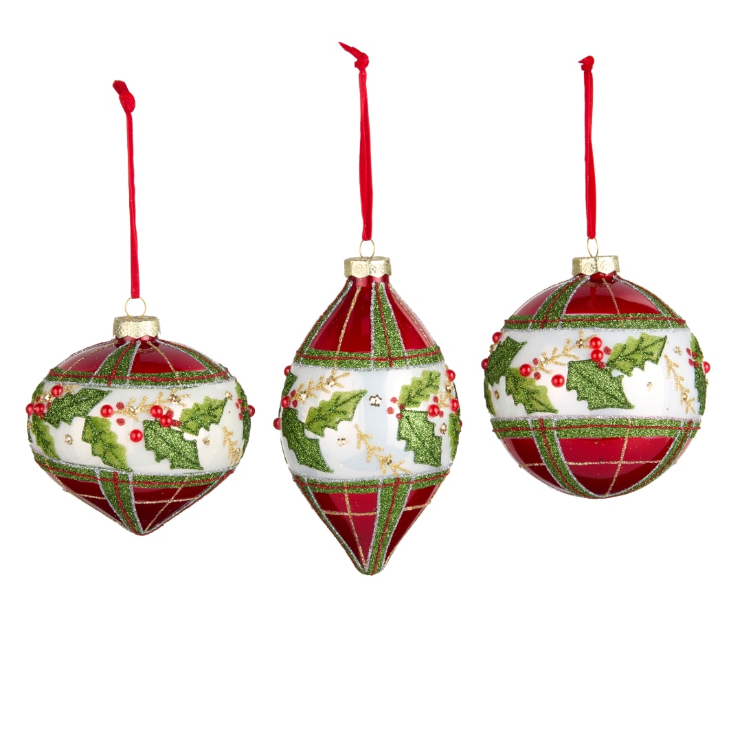 Three red and white Christmas ornaments with holly designs