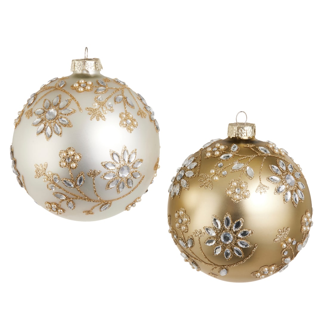 Two jeweled gold and ivory Christmas ornaments with floral patterns