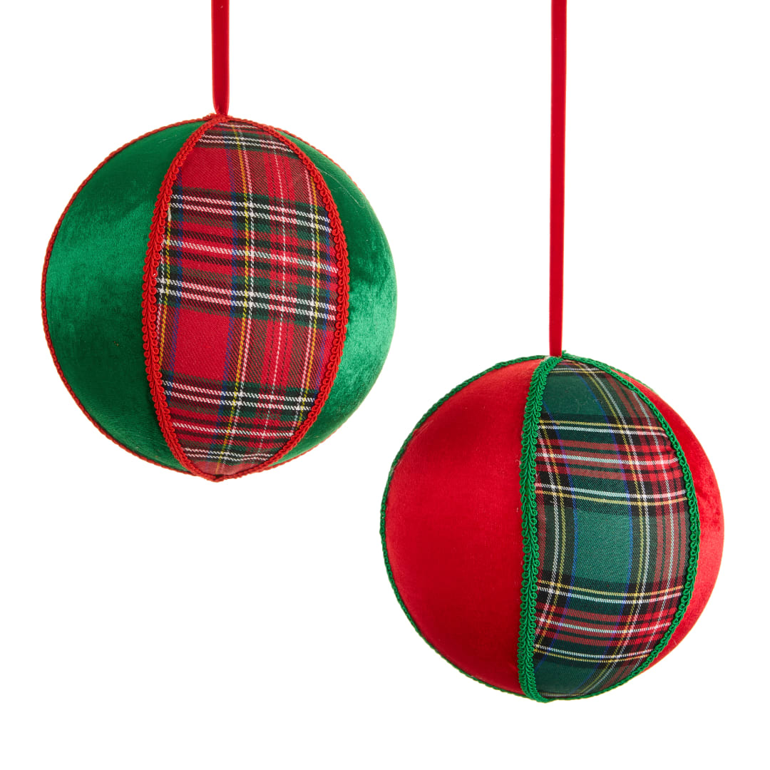Two plaid Christmas ornament balls hanging on red ribbons