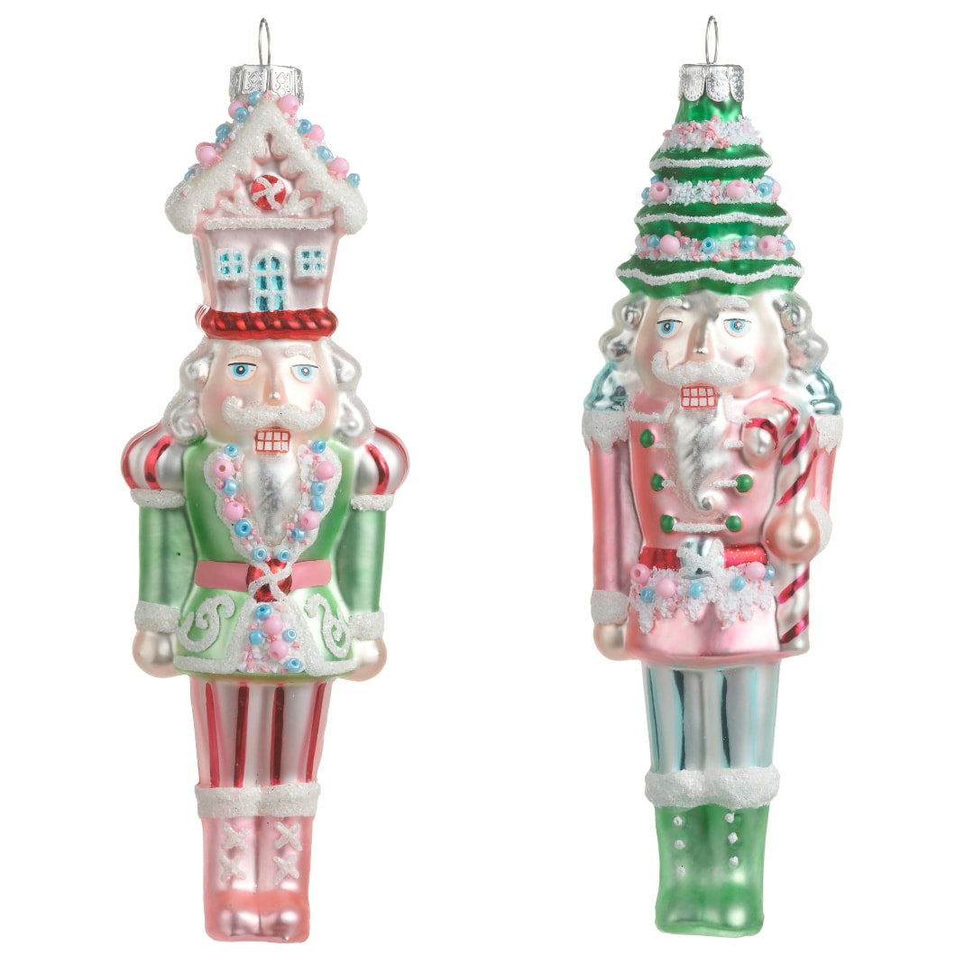 Two Christmas nutcracker ornaments with pastel pink and green details