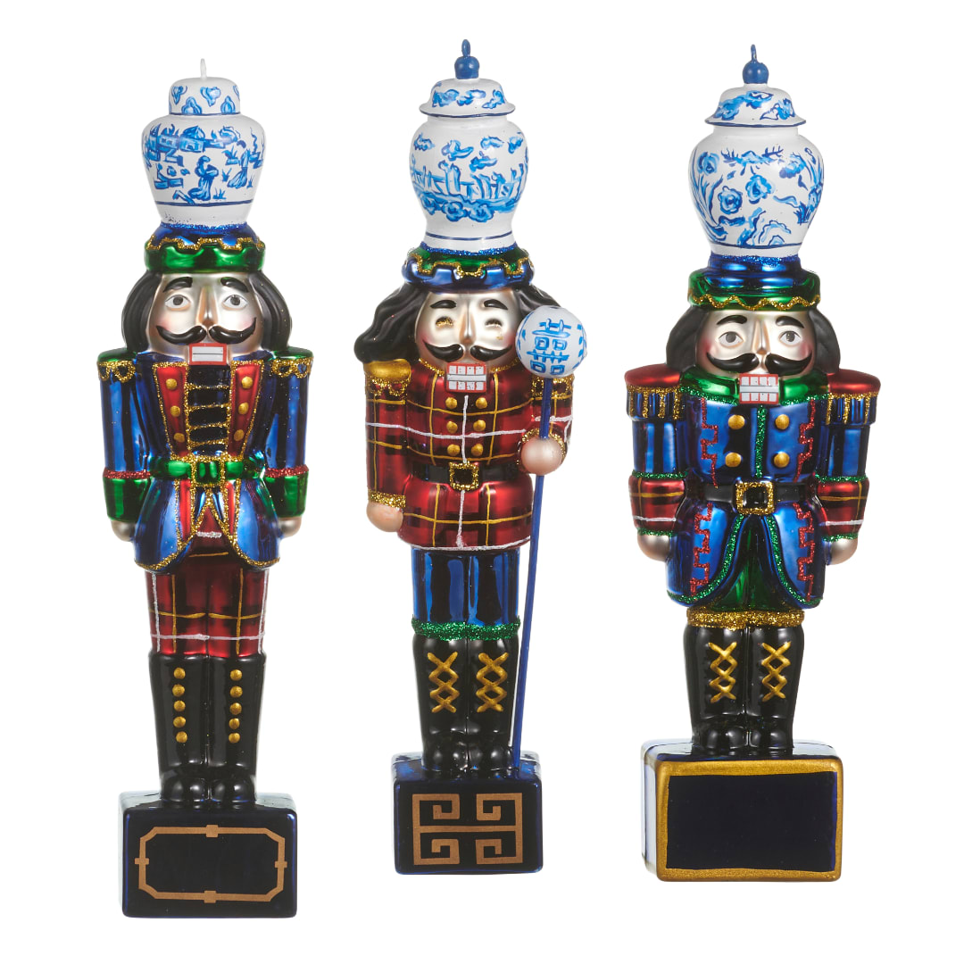 Three decorative nutcracker figurines with blue-and-white urns on top