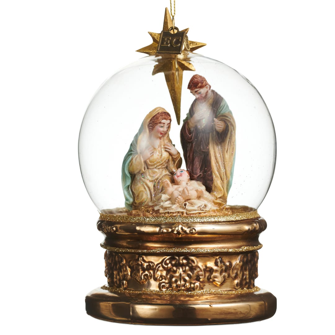 Nativity scene inside a clear glass snow globe with a gold base