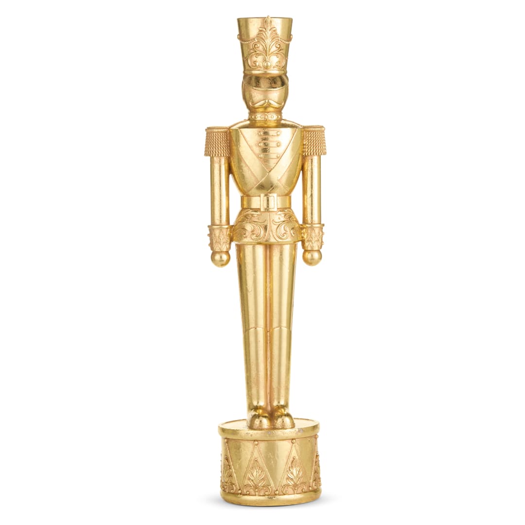 Gold nutcracker figurine standing on a round base