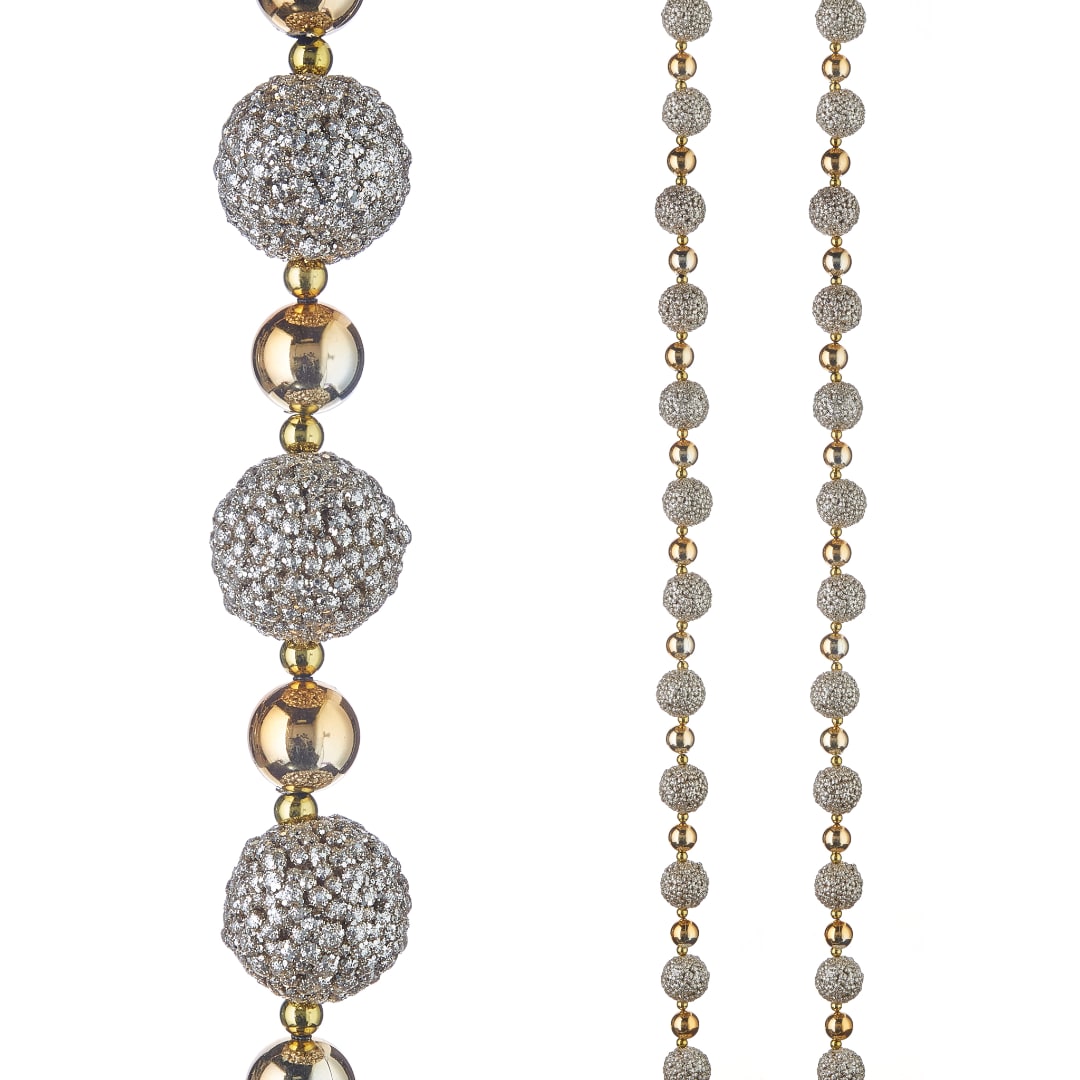 Sparkling beaded garland with silver and gold spheres on a white background