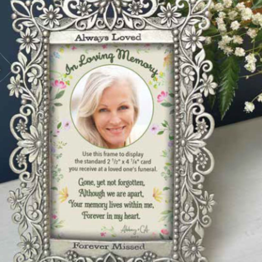 Decorative memorial frame with a portrait and floral accents