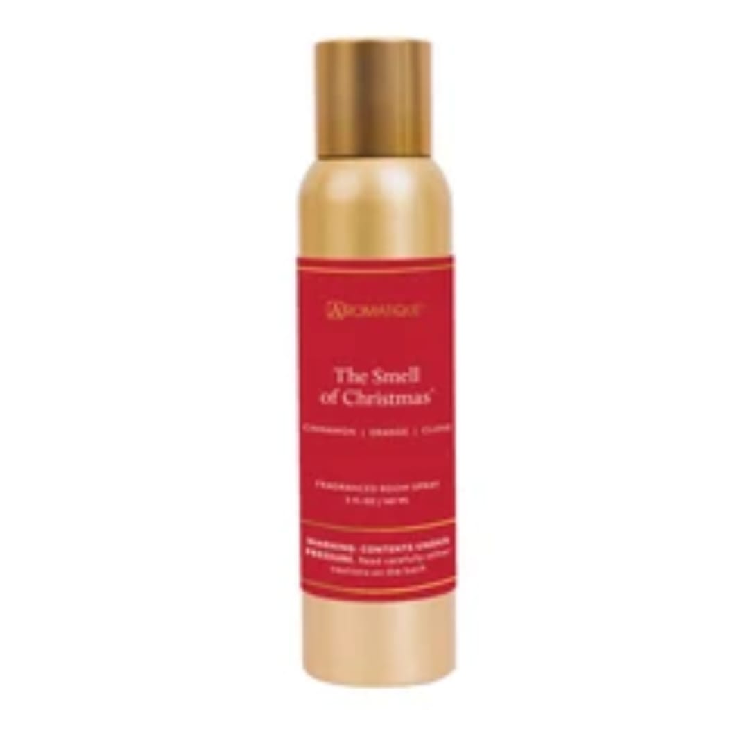 Gold and red spray bottle labeled The Smell of Christmas