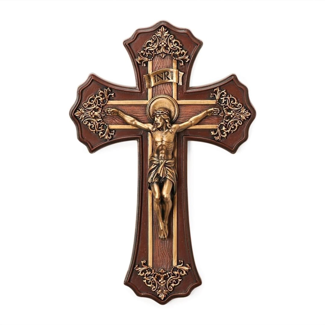 Ornate wooden crucifix with a figure of Jesus on a white background