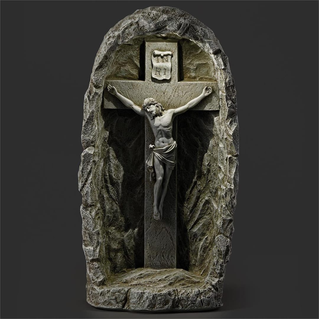 Stone crucifix with a carved figure of Jesus in a rock-like niche