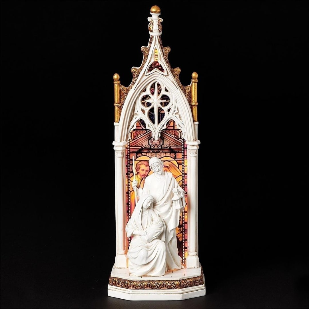 White religious figurine in a gothic arch frame on a black background