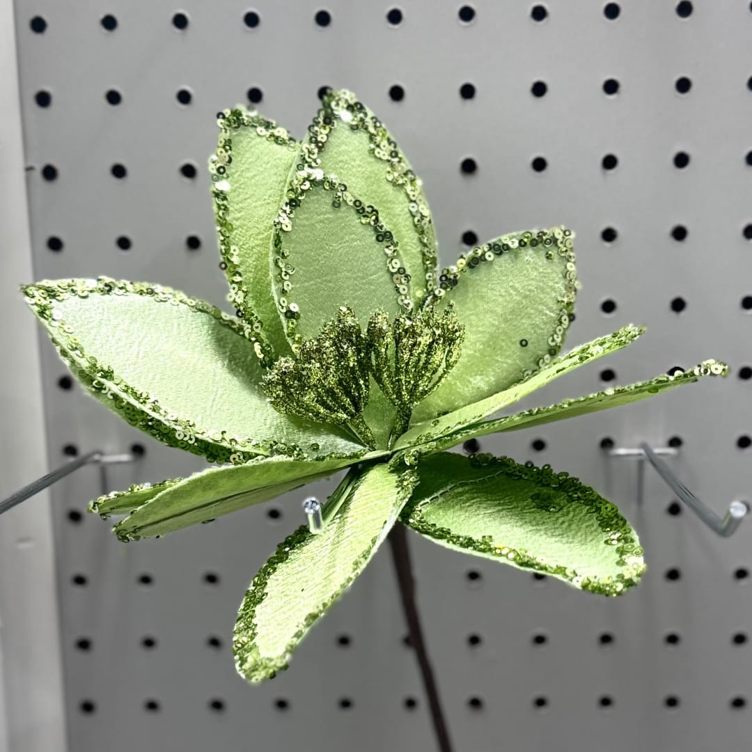 Green glittered artificial flower on a display peg