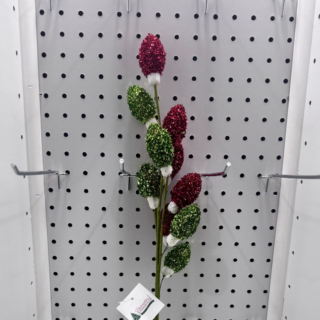 Decorative stem with red and green glittered buds on a pegboard display