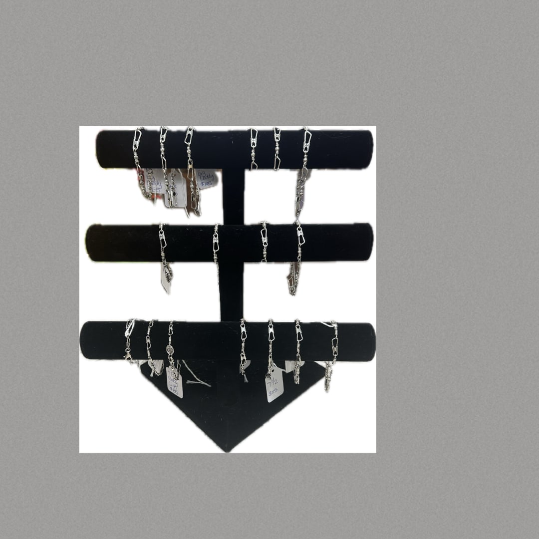 Jewelry display board with several dangling silver chains and tags