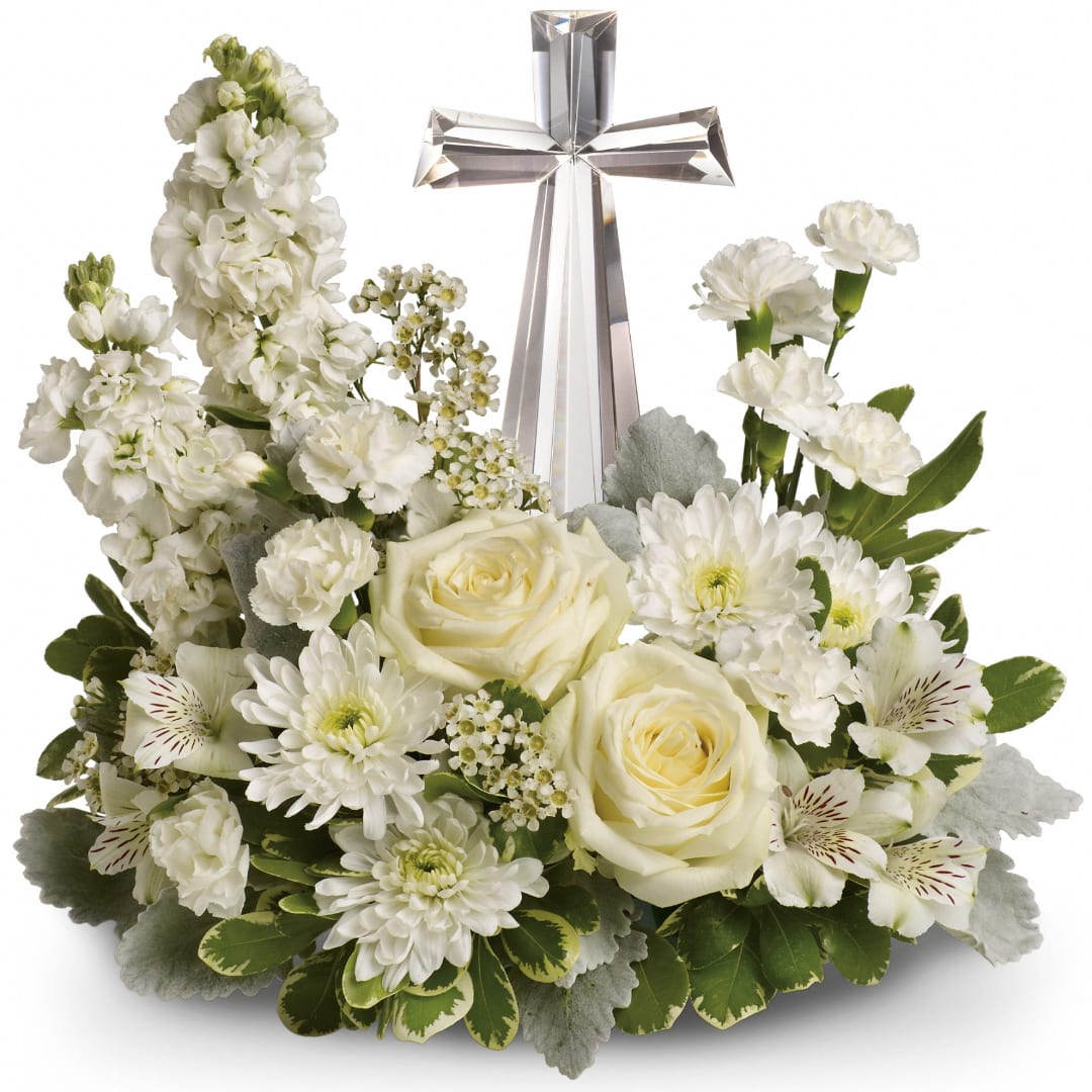 White floral arrangement with a silver cross centerpiece