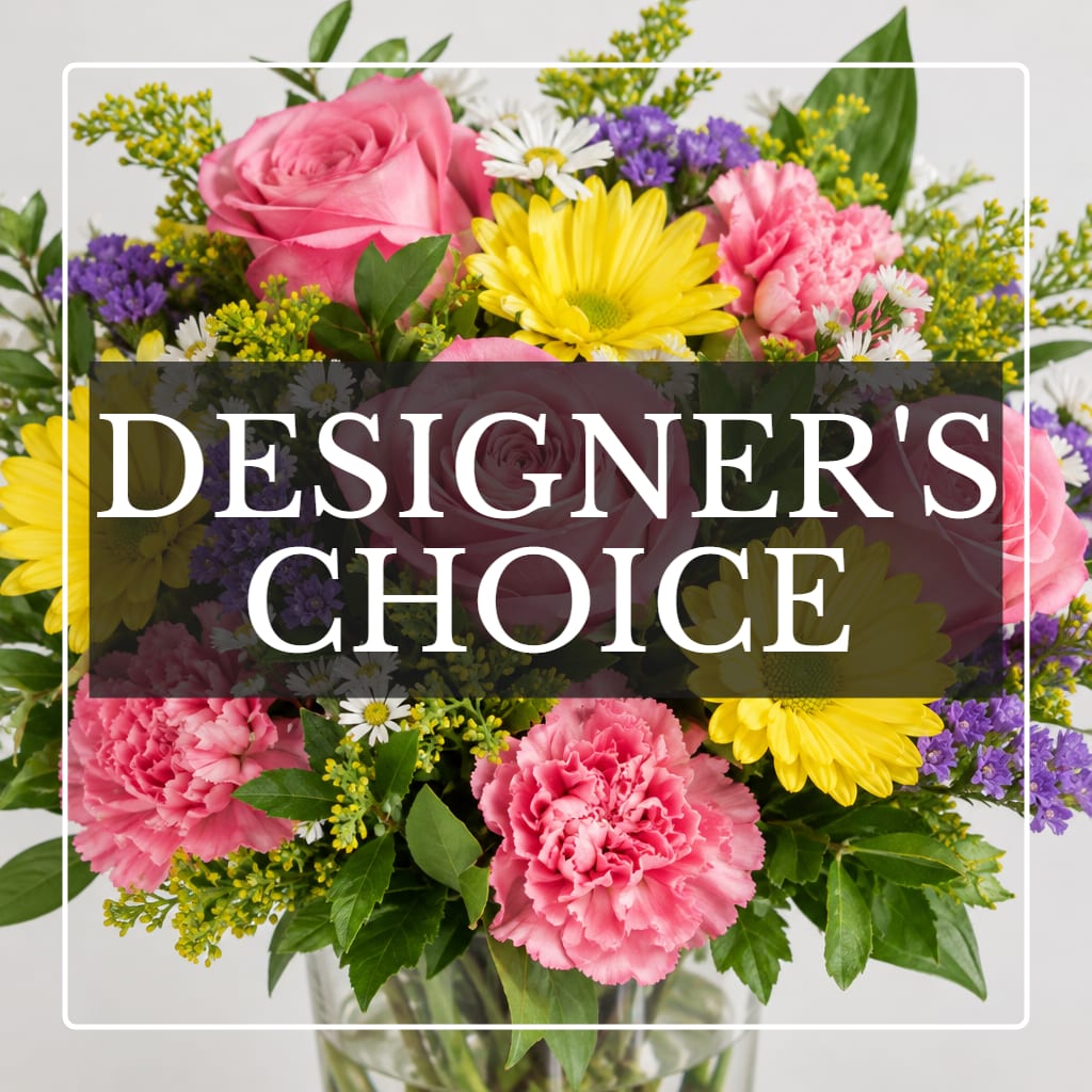 Mixed bouquet of pink roses, carnations, and yellow daisies in a glass vase