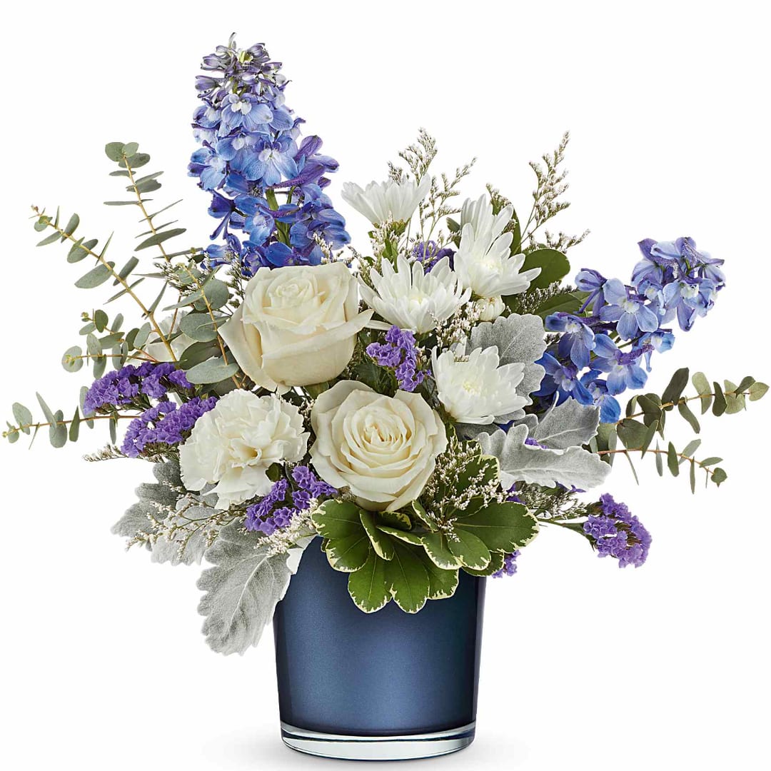 White roses and purple-blue flowers in a blue vase