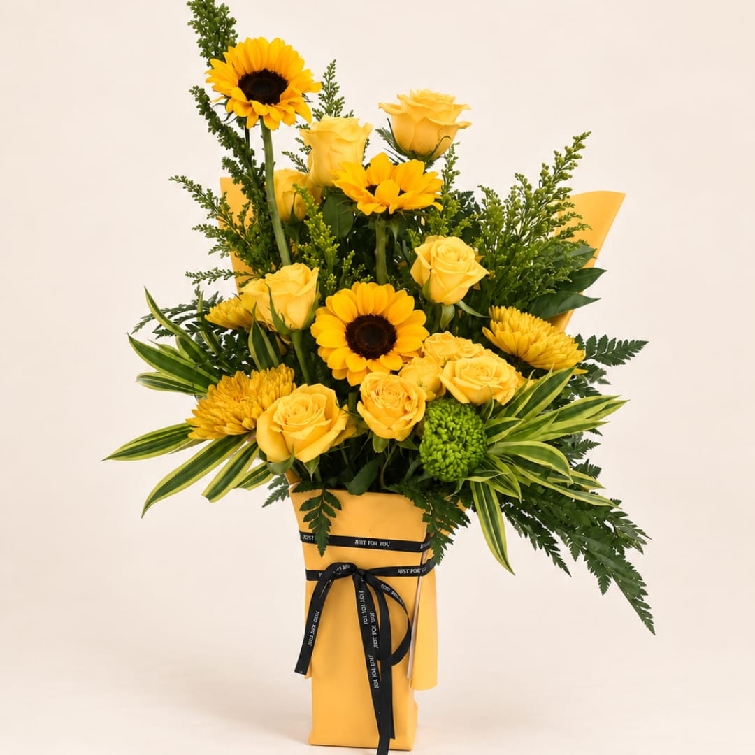 Yellow roses and sunflowers in a wrapped bouquet with a black ribbon