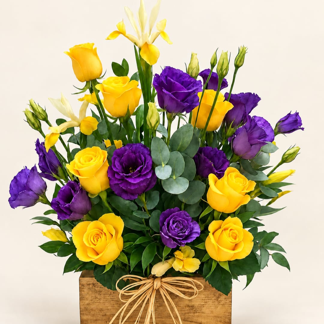 Yellow roses and purple lisianthus in a wooden box with a bow