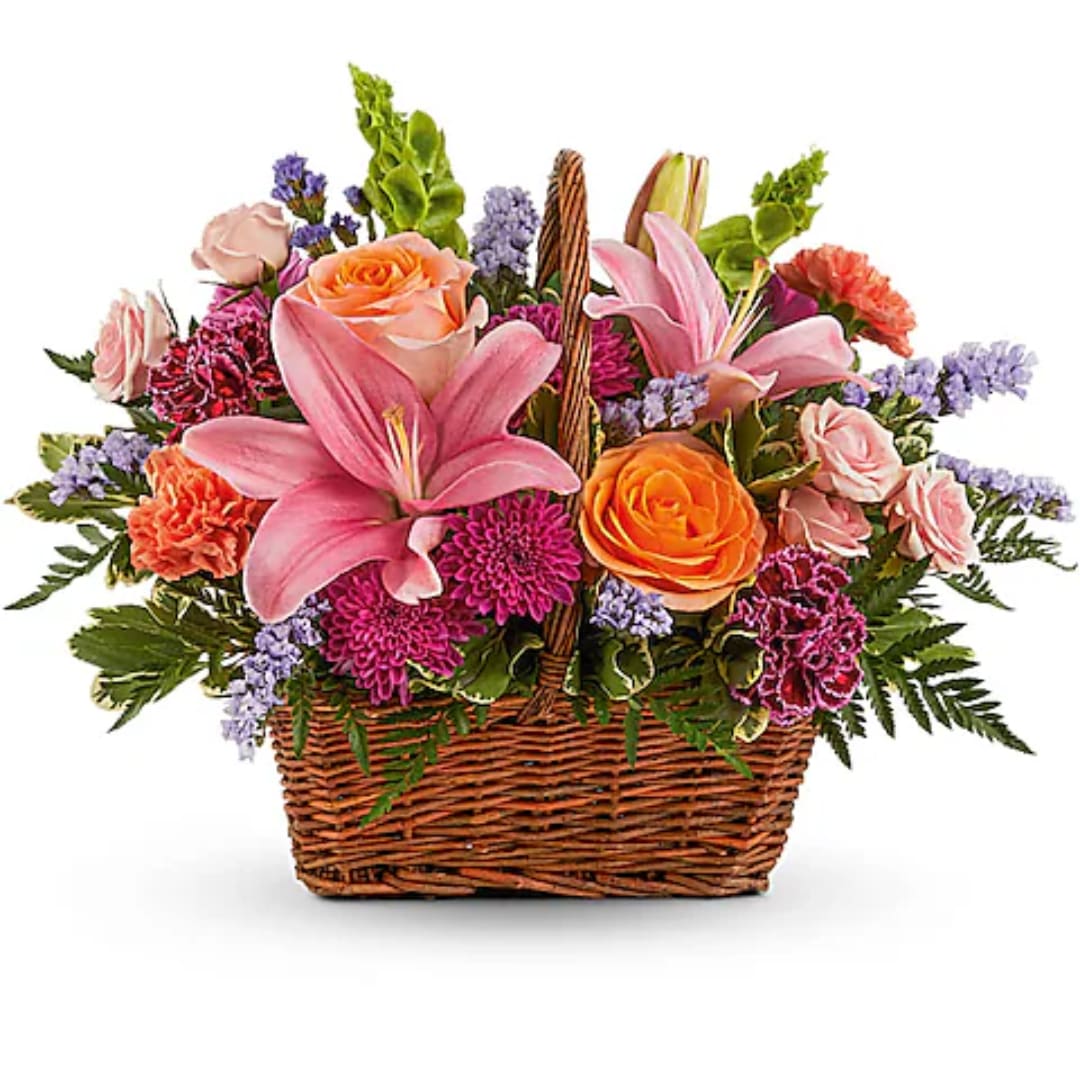 Basket arrangement with pink lilies, roses, and mixed blooms