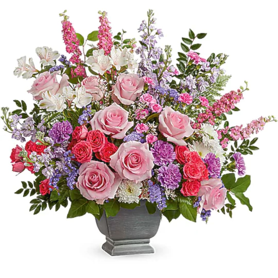 Pink and purple mixed flower arrangement in a gray urn vase