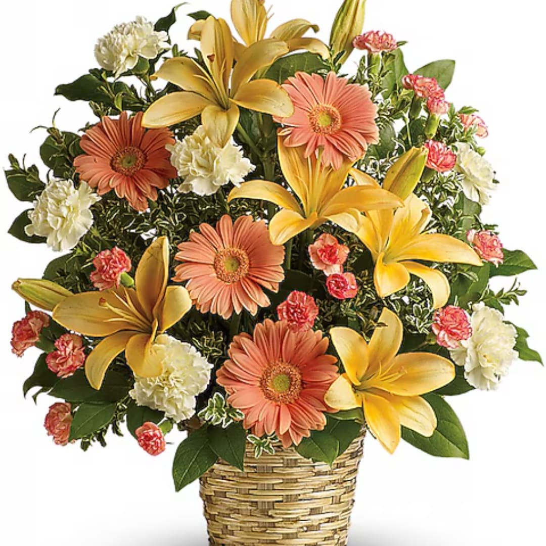 Mixed bouquet of lilies, gerbera daisies, and carnations in a woven basket