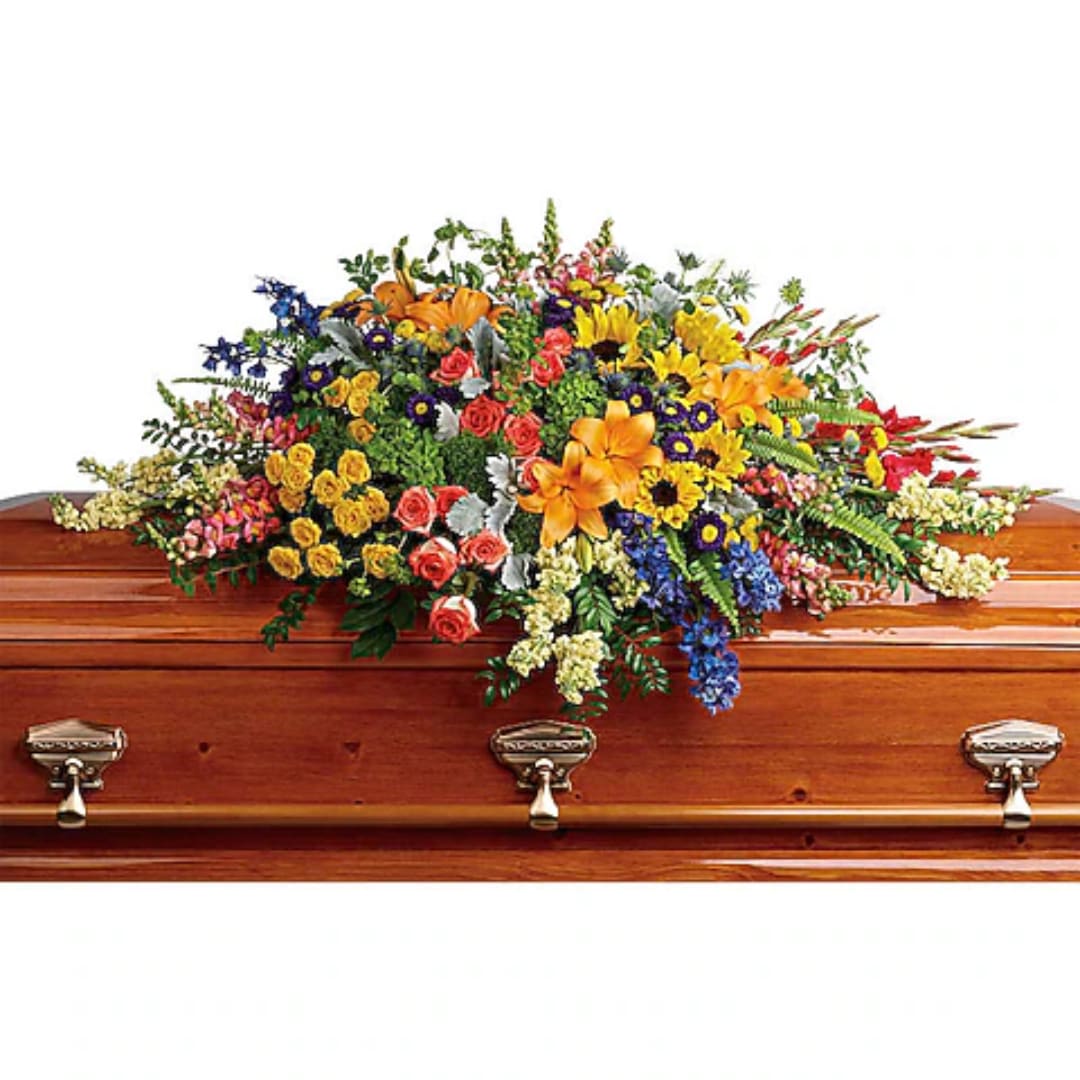 Colorful flower spray arranged on a wooden casket