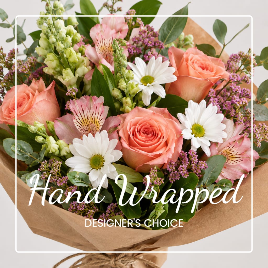 Hand-wrapped bouquet of peach roses, white daisies, and pink flowers