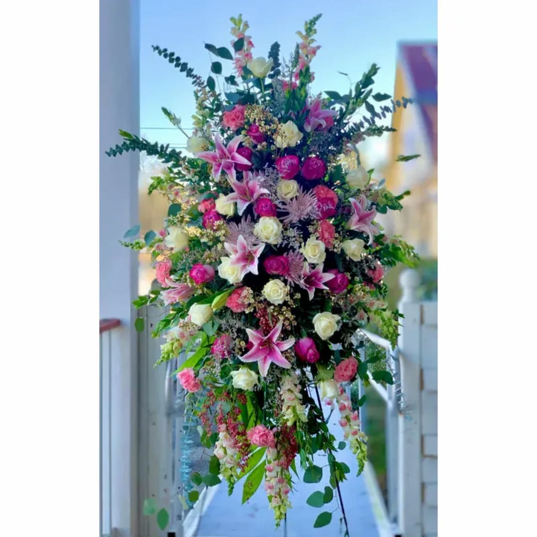Tall floral spray with pink lilies and roses in a lush mixed arrangement