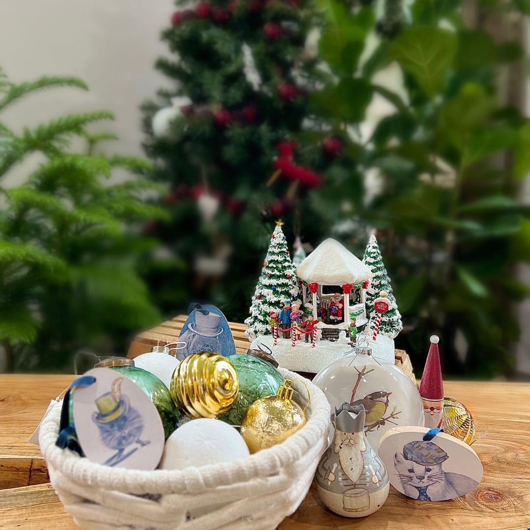 Christmas ornaments and figurines arranged on a wooden table
