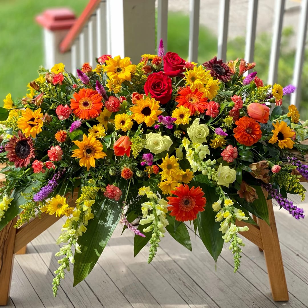 Large mixed flower arrangement with roses, gerbera daisies, and yellow blooms