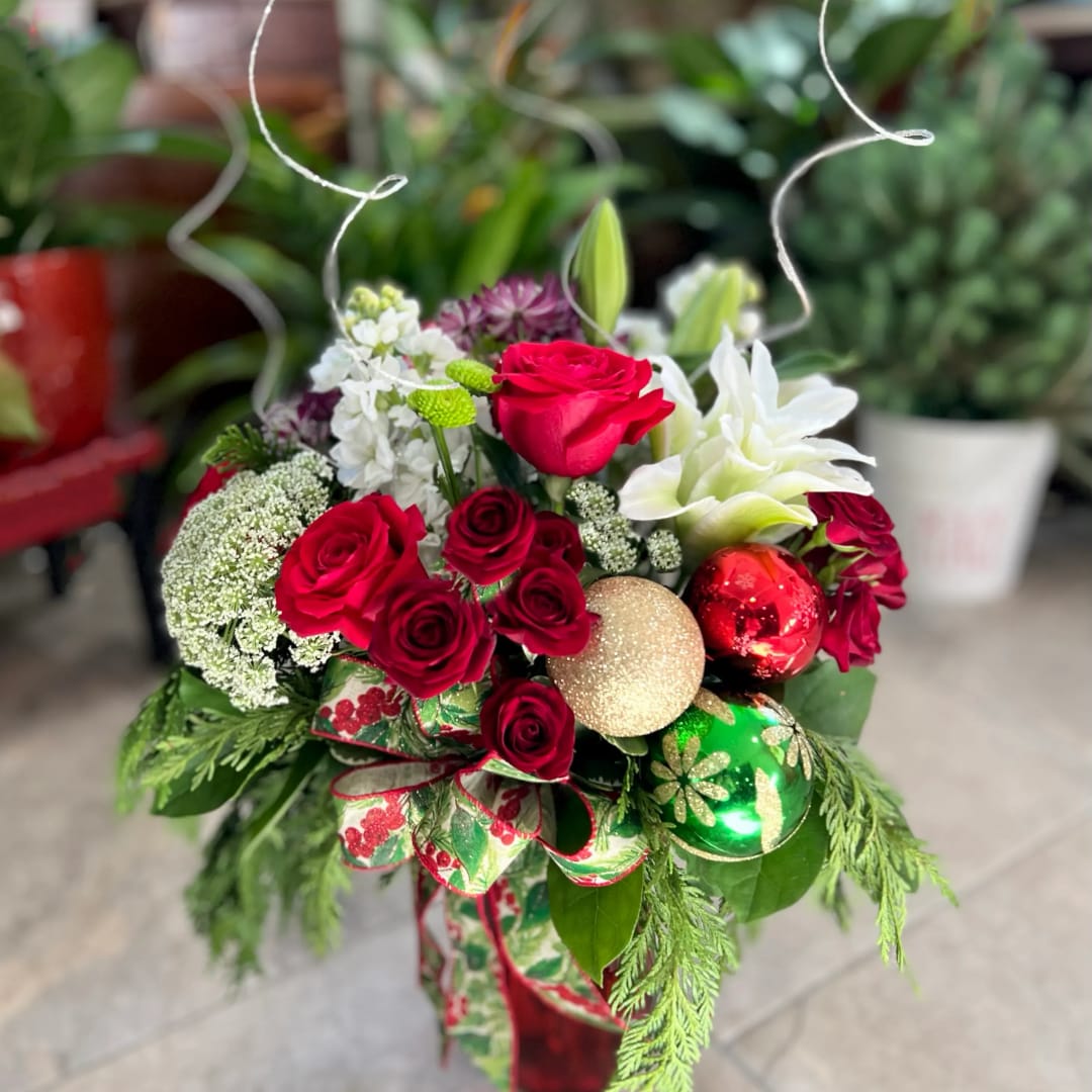 Holiday bouquet with red roses, white lilies, and Christmas ornaments