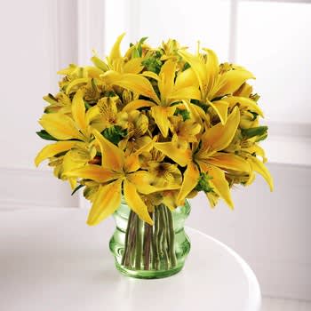 The Go Green Bouquet - Best - Our "Go Green" Bouquet holds yellow Asiatic lilies and yellow alstroemeria with bupleurum for added interest. Vase is eco-friendly and biodegradable.