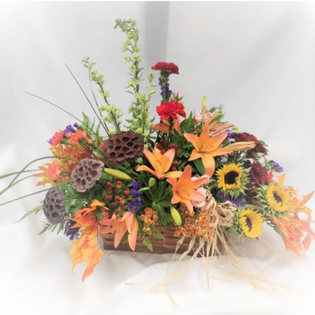 Mixed floral basket with orange lilies and sunflowers