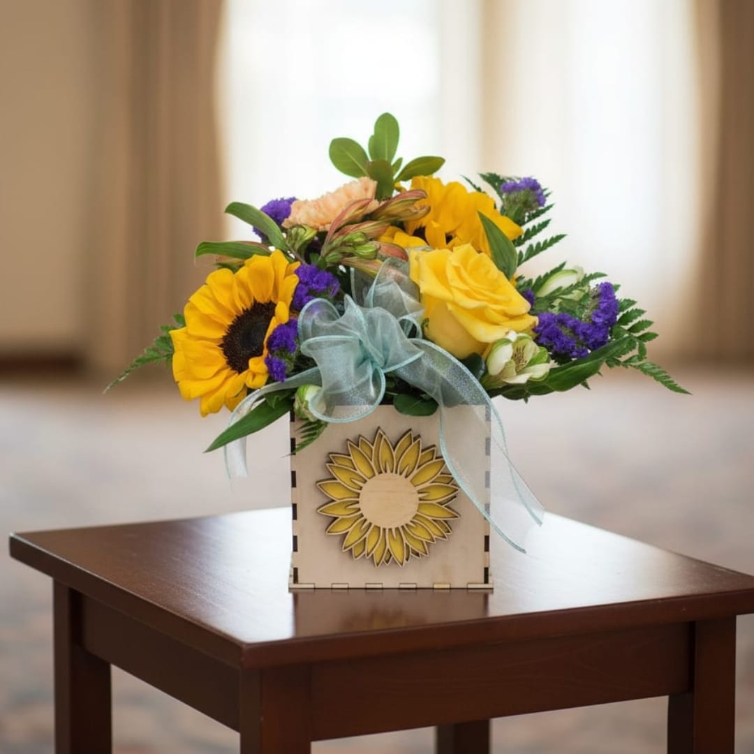 Sunflower and yellow rose arrangement in a wooden box with a blue ribbon