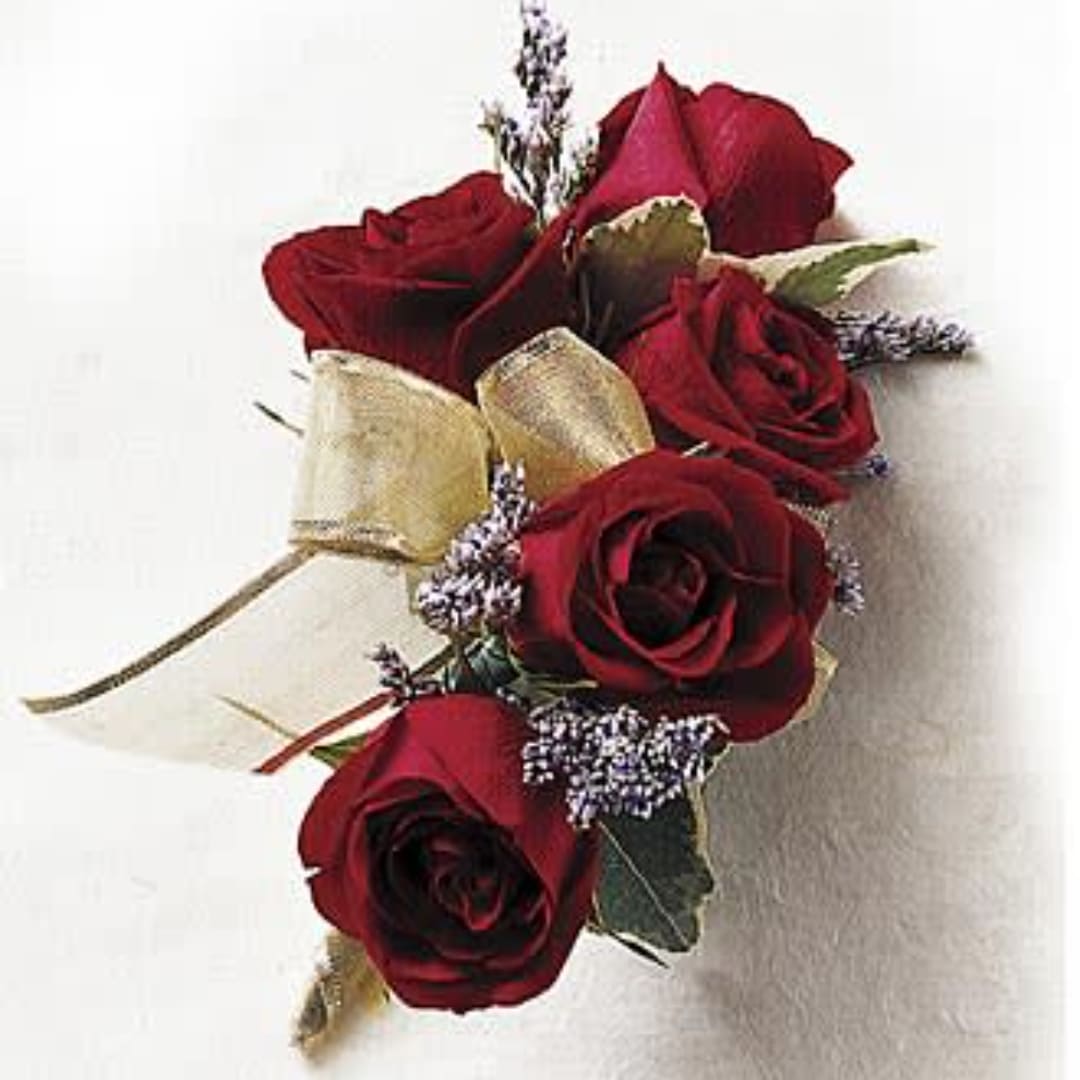 Corsage with red roses and gold ribbon on a white background