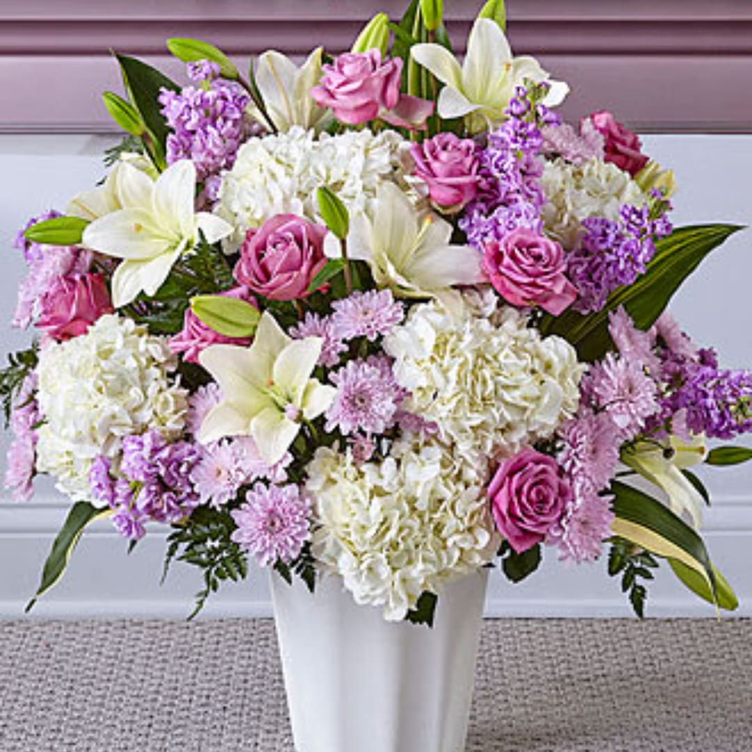 Pink and white mixed flower arrangement in a white vase