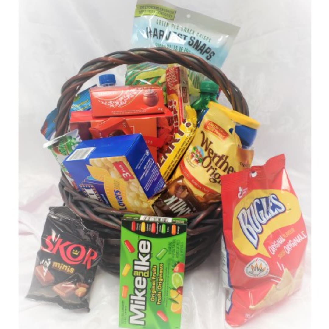 Basket filled with assorted snack bags and candy boxes