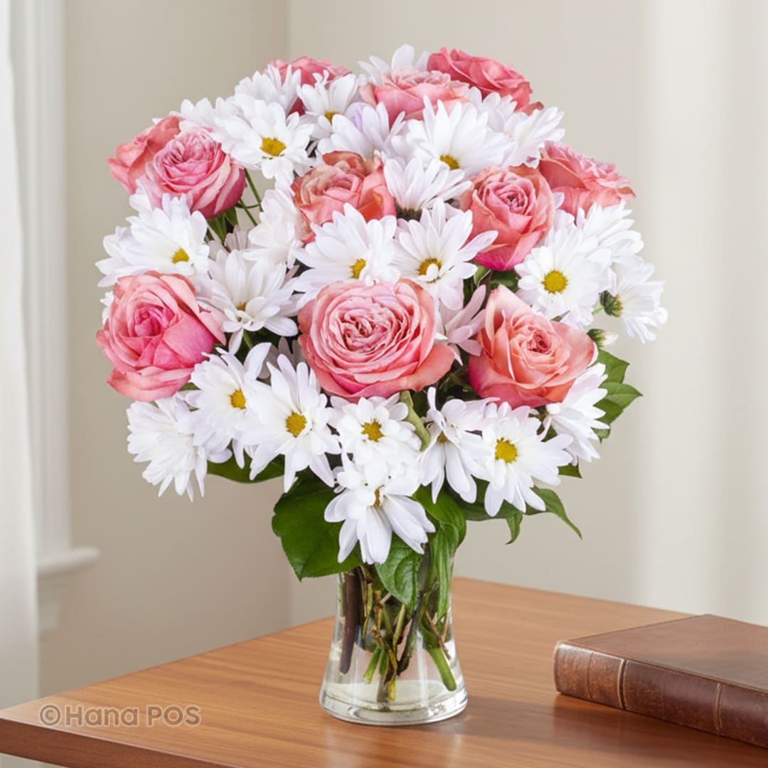 Pink roses and white daisies in a clear glass vase
