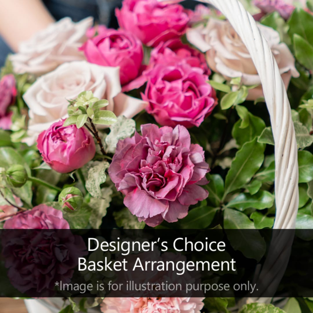 Basket of pink and blush roses with greenery