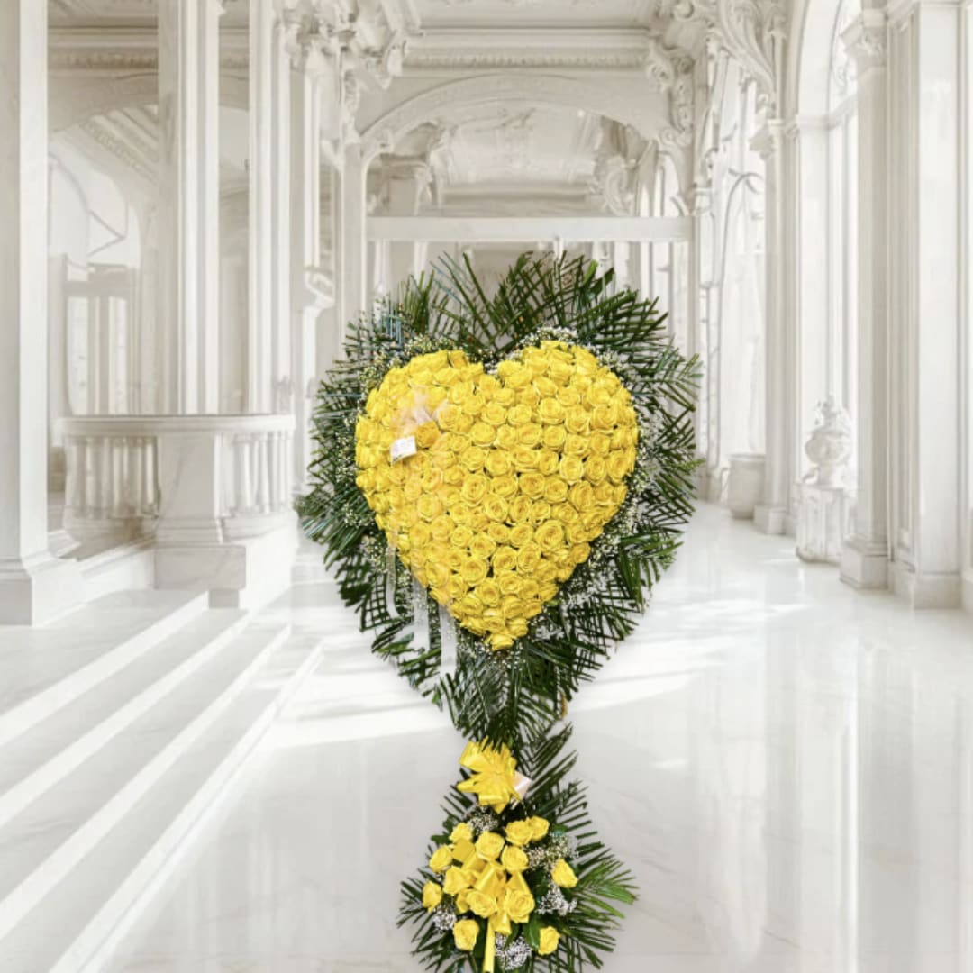 Yellow rose heart-shaped standing spray with greenery