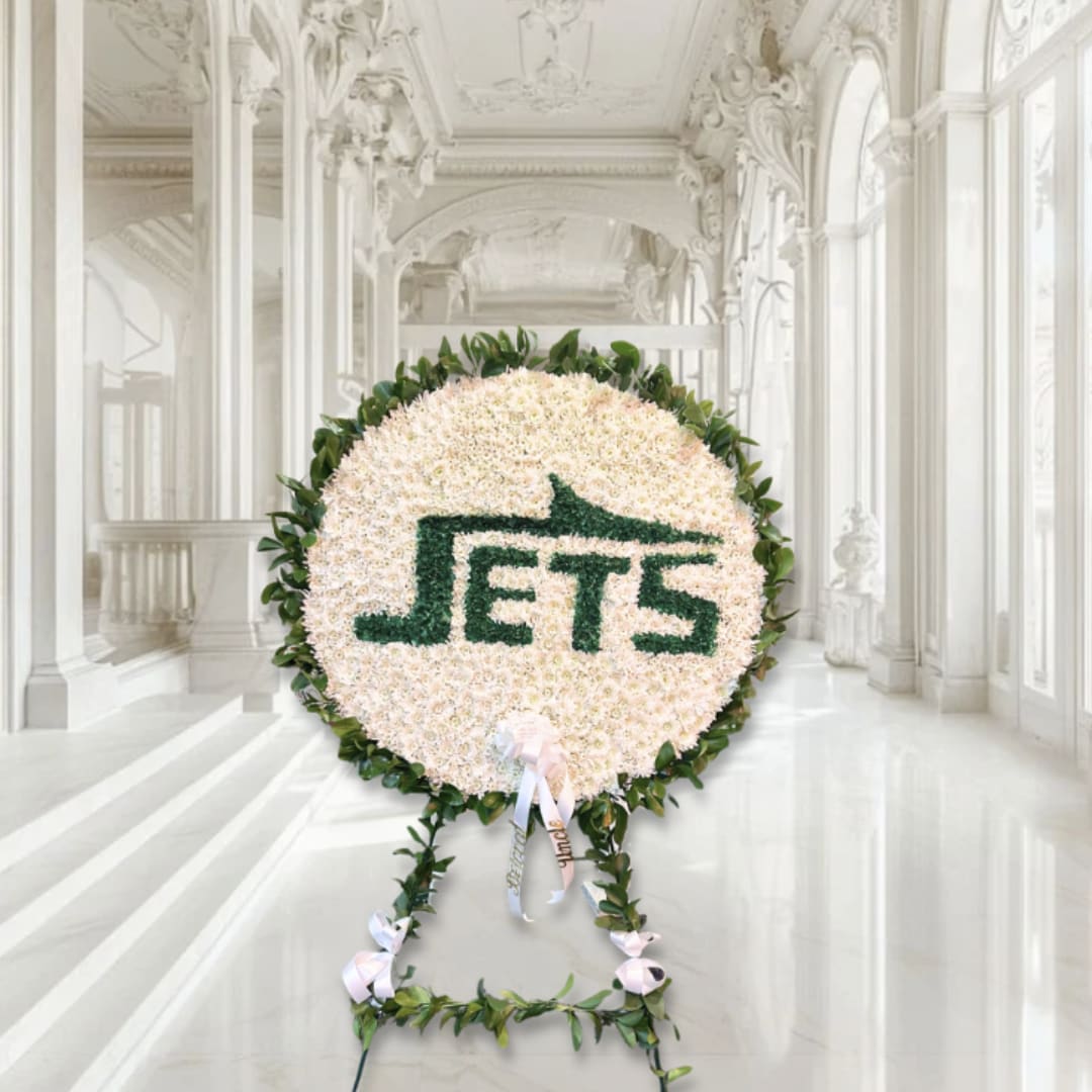 Large round floral display with the word JETS in green flowers