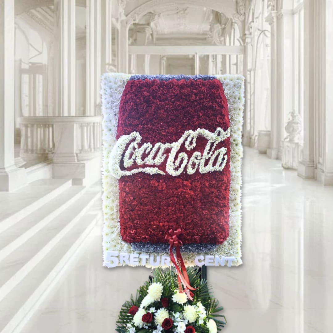Standing floral tribute with a Coca-Cola logo and red-white flowers