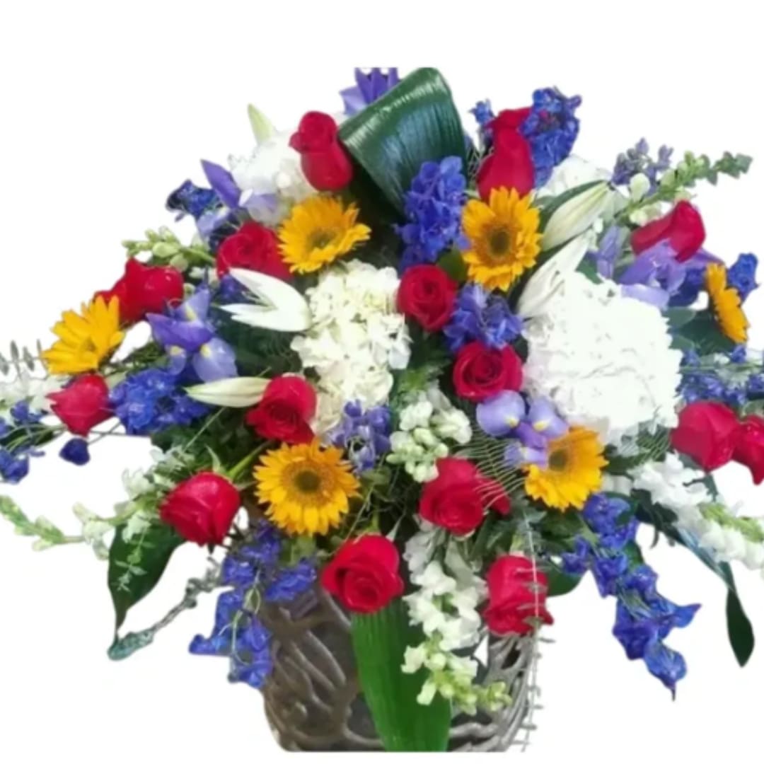 Mixed bouquet with red roses, white lilies, yellow daisies, and blue flowers in a vase