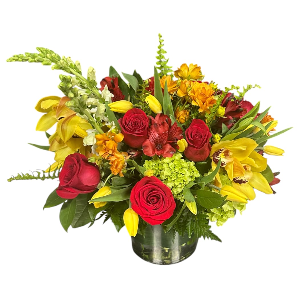 Mixed bouquet of red roses and yellow flowers in a glass vase
