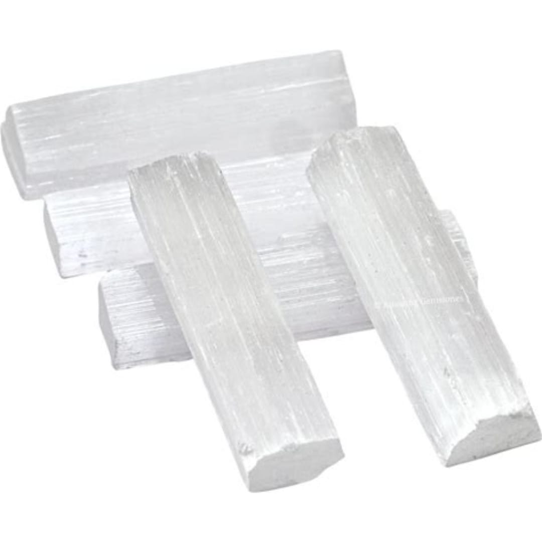 Four white selenite crystal sticks arranged on a white background