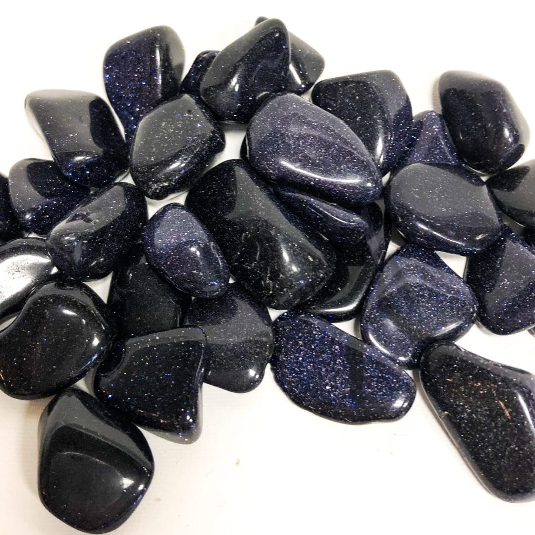 Pile of polished dark blue-black stones with glittery flecks