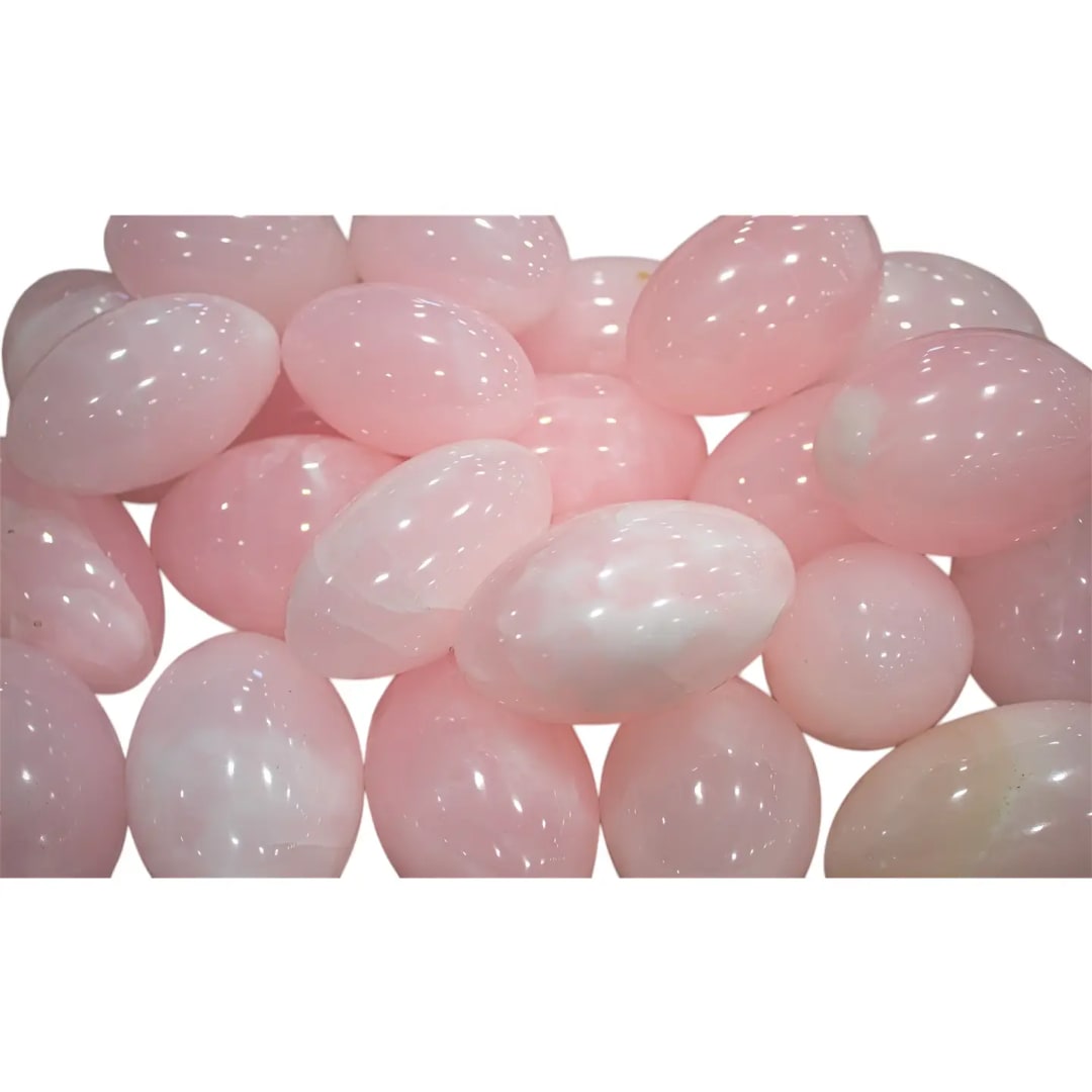 Cluster of pale pink polished stones on a white background