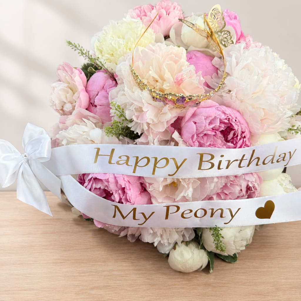 Pink and white peony bouquet with a birthday ribbon and bow