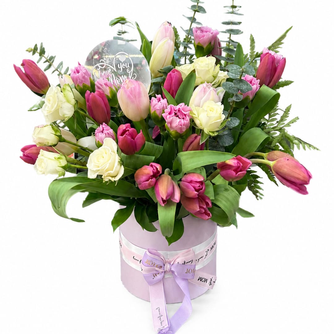 Bouquet of pink and white tulips with roses in a lavender box