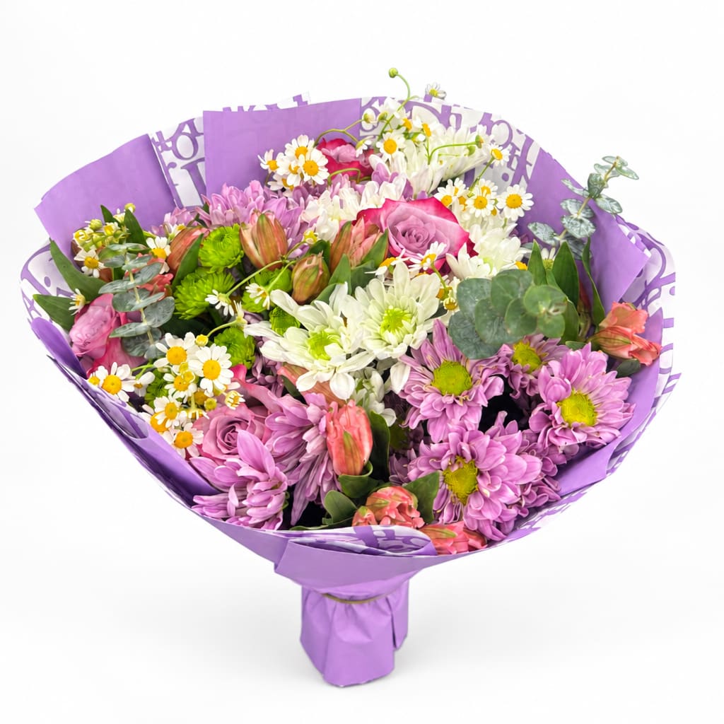 Bouquet of pink, white, and purple flowers wrapped in lavender paper