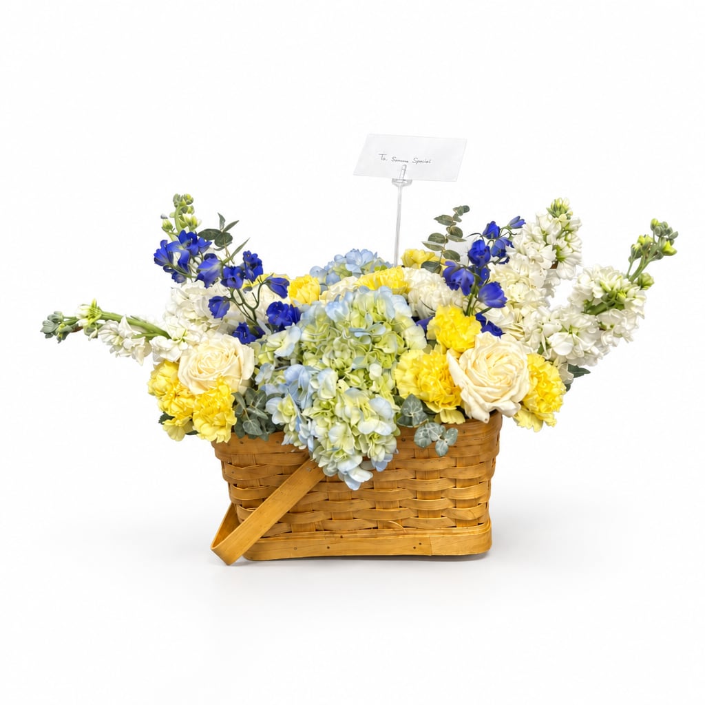 Basket arrangement of blue, yellow, white, and pale green flowers